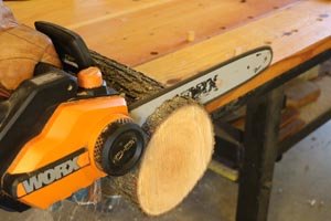 Use a chainsaw to create round disc for both ends of the log bird feeder.