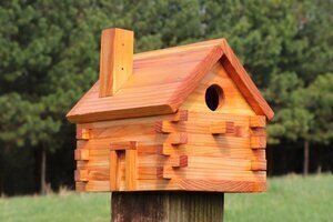 Finished log cabin bird house.