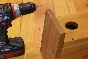 Nesting box roof attached with screws.