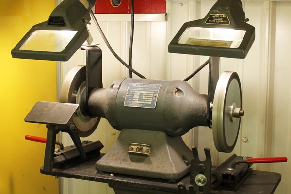 This bench grinder has the equivalent of 100-watt light bulb above each wheel.