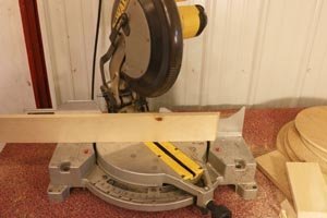 Miter saw set to 30-degree angle for hexagon wall shelf.