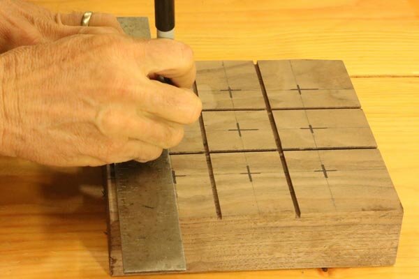 Mark holes on tic-tac-toe board for pegs.