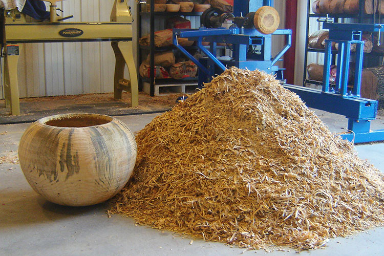 The finished bowl along with the wood chips used to create it.